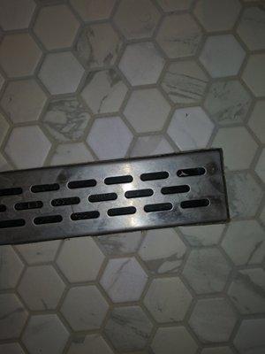 Chipped tile around linear drain