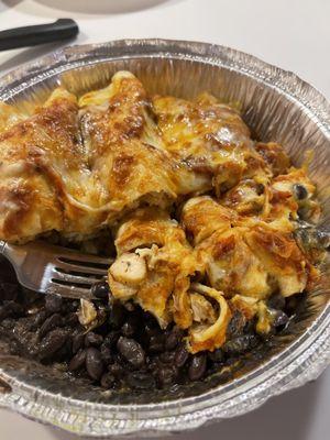 Cheesy chicken enchiladas with rice and beans