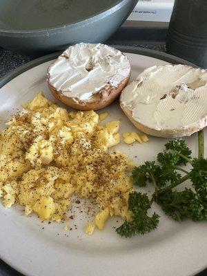 Scrambled eggs and bagel with cream cheese