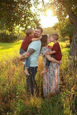 Family photography portrait of a young family parents holding them against their chests snuggling in durham new hampshire