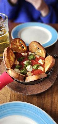 Crostini with marinara, goat cheese, and pesto dip