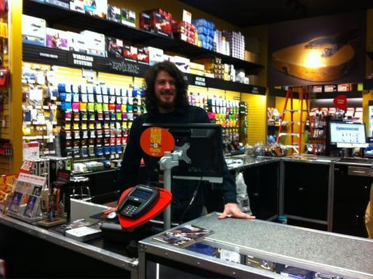 One of the plaid-clad Guitar salespeople, standing by for your transaction.