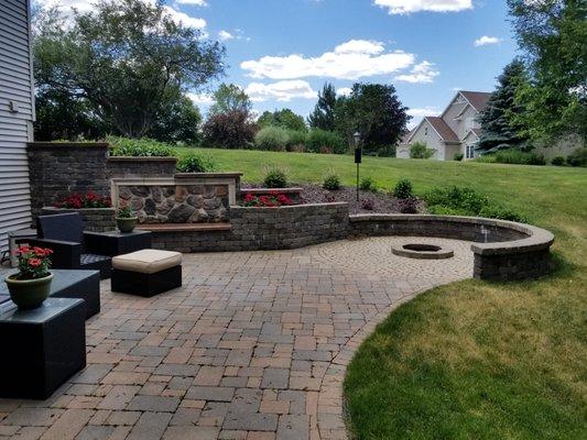 Retaining wall with a bench.  Plus a paver patio with a fire pit.