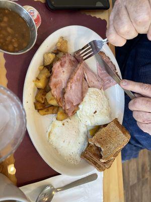 He got 3 eggs with ham, comes with homefries, toast and beans.