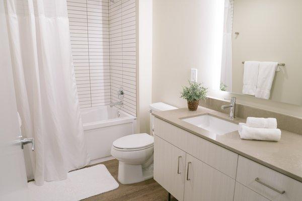 Large bathroom with a soaking tub, rain shower and a backlit mirror to create that perfect light.