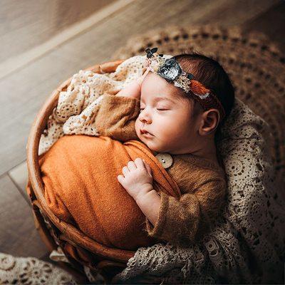 Newborn girl in boho basket