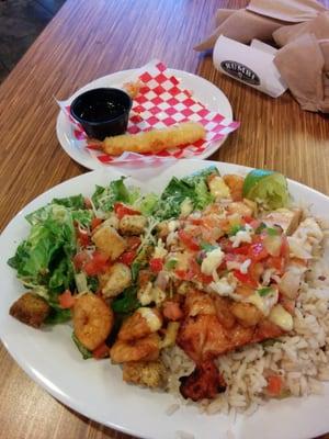 Chicken,shrimp, Caesar salad, rumbi rice which has coconut milk in it, tempura shrimp on the side. Outstanding meal