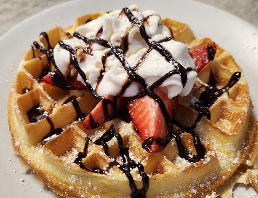 Belgian Waffle with strawberries, whipped cream, & chocolate sauce