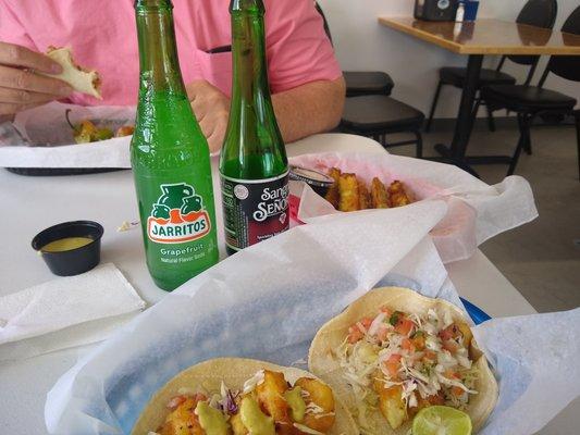 Fish taco, shrimp taco, fried zucchini, and Mexican sodas.