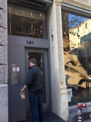 Street entrance, press 2B, then walk up a narrow stair to the second floor