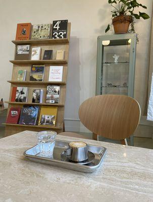 Our macchiato served with soda water & our books for sale