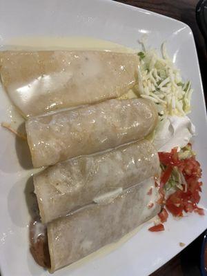 Enchilada special with cheese sauce