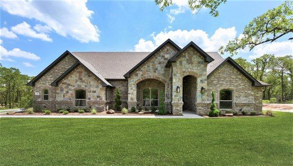 Popular new construction home with stone & brick  in Paradise, TX by Doug Parr Homes construction company.