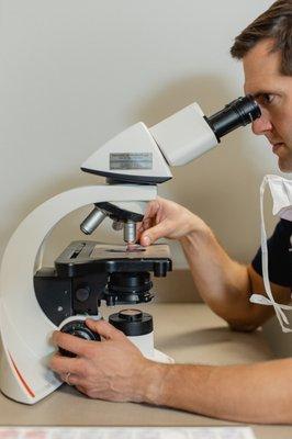 Microscopic examination for skin cancer screening.