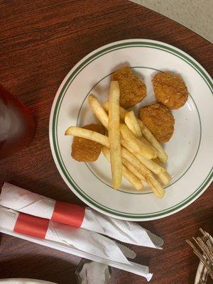 Kids chicken nuggets and fries split in two