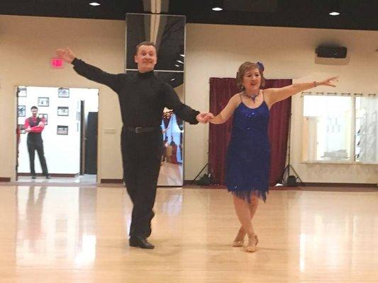 Denis dancing with student at Holiday Dance Showcase