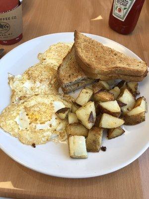 Fried eggs, hash browns and wheat toast