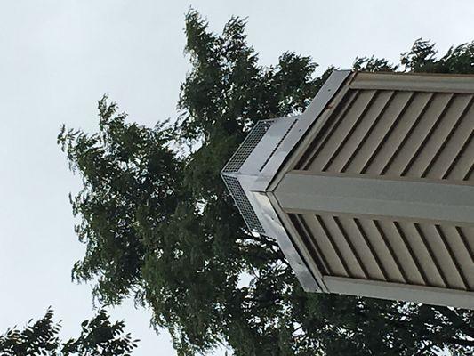 Dented and scratched "new" chimney cover. Nails are popping out and rusting. Edges are very rough as though cut with tin-snips. Not sealed.