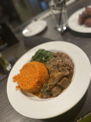 Goat Stew, Jollof Rice and collard greens