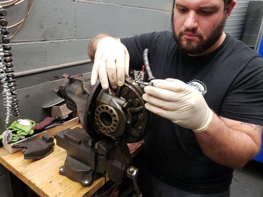 Our foreman taking measurements while rebuilding the differential on a customer's car.