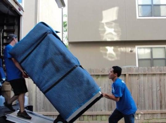 Loading the truck carefully while protecting belongings.