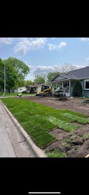 Grading and installing new sod for house