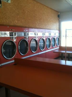 Row of dryers against back wall. There are 16 dryers