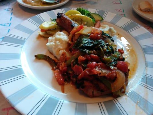 Pork chop with garlic mashed potatoes and veggies.