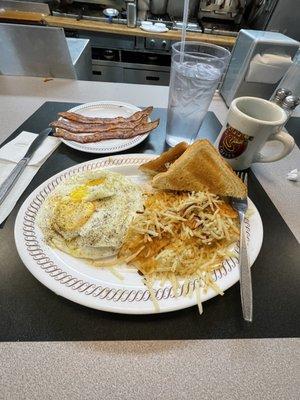 3 eggs over medium, hash browns, bacon, toast, coffee & ice water.