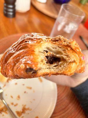 A perfectly flaky chocolate almond croissant with lots of almond taste to it.