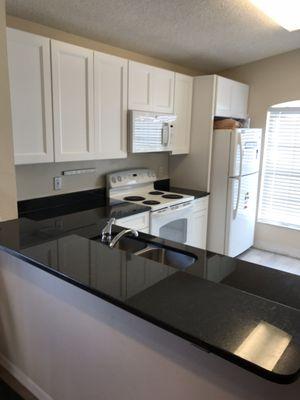 Cabinets uptown white and counter black pearl.