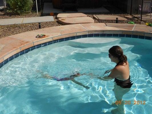 Sunsational Instructor Morgan teaches this two year old how to swim under the water in her home pool.