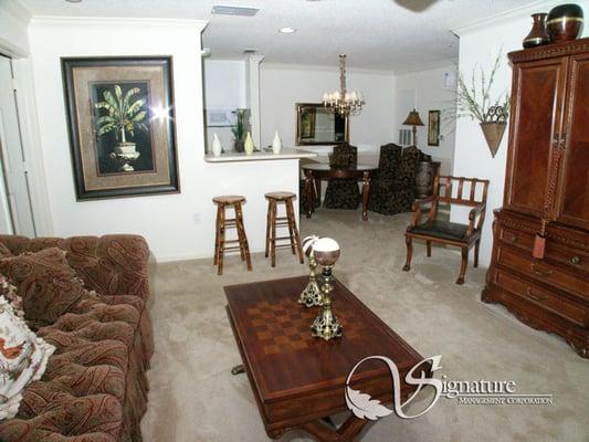 The living room and kitchen area of an Alexander Falls apartment home.