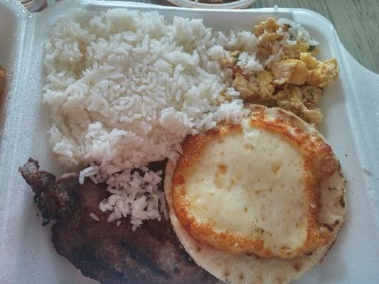 Steak, rice, scrambled eggs, arepa