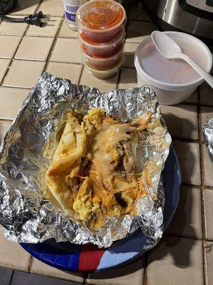 Migas taco with ranchero sauce, refried beans and cheese.