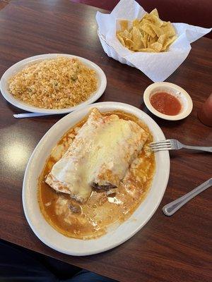 2 "shredded beef" burritos with red sauce and cheese sauce and a side of rice.