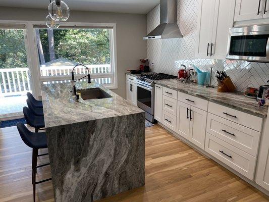 Kitchen with a waterfall island. We used two slabs, so that the veining transition was seamless.