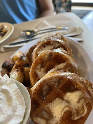 GF Cinnamon roll Belgian waffles with home fries and whipped cream on the side