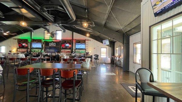 Bar and some sitting area. There is a pool table just to the left of the tables.