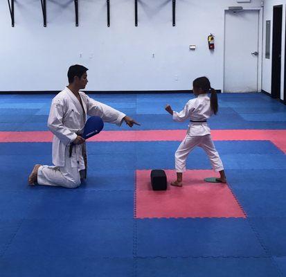 Younger daughter, nervous and shy at first but now loves it. Sensei's way with kids put her at ease and built more confidence.