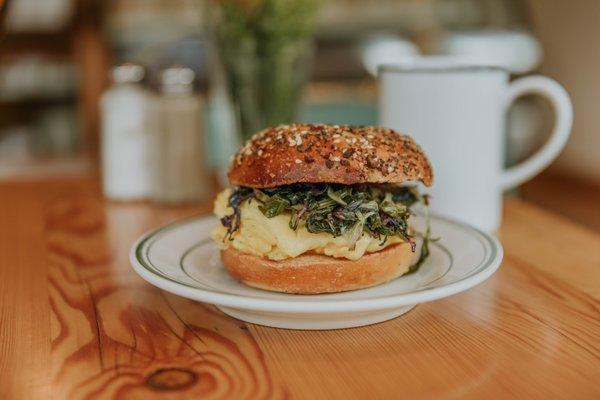 Egg and greens on an everything bagel