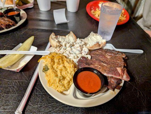 Pork ribs plate with broccoli n cheese and macaroni salad for sides. Spicy BBQ sauce on side.