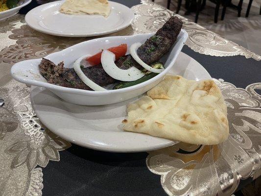 Side dish of lamb with pita bread.