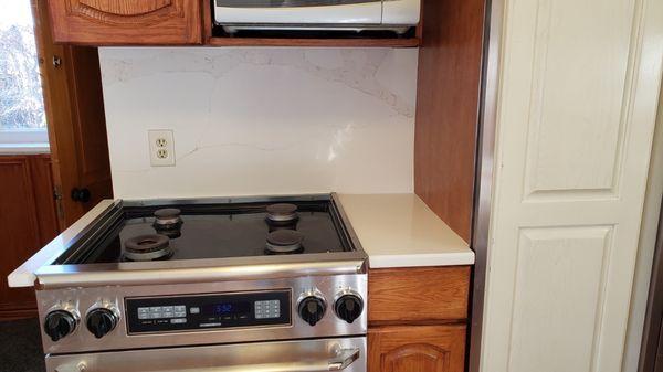 Stove and countertops and splash-back they made a small 3" ledge on the left side of the stove to make it look better.