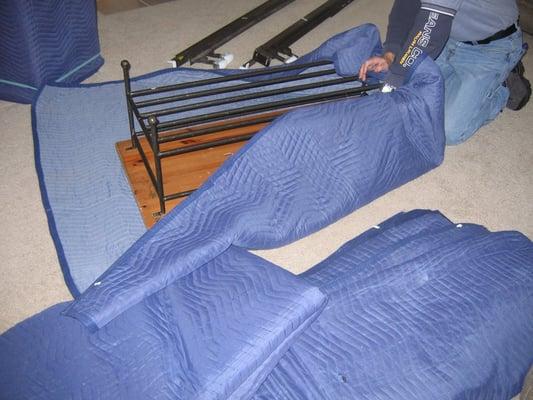 Protecting furniture by wrapping in moving pads