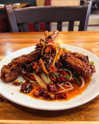 Lamb chops on warm bean sprouts and onions