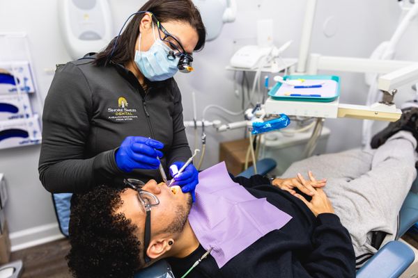 Patient receiving dental cleaning at Shore Smiles Dental