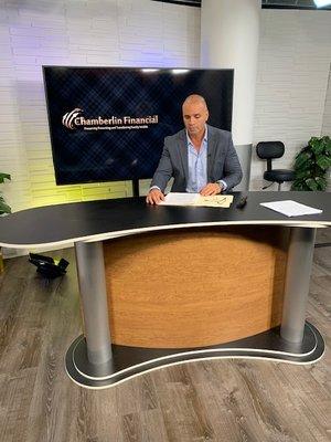 Stuart Chamberlin in the studio shooting a series of informative videos on financial defense.