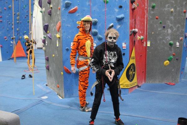 Team kids dressed in their Halloween costume, getting ready to climb on top-rope before our Lights Out Event.