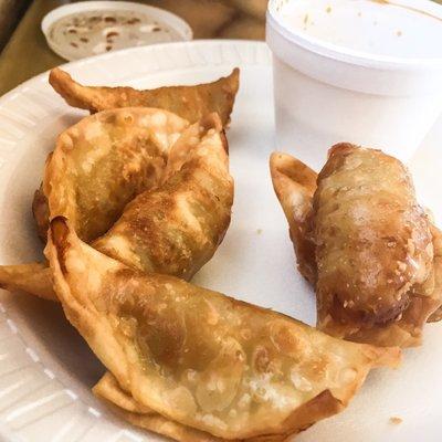 Fried pot stickers with dipping sauce.